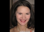 Alicija dark is sited on a sofa, legs appart and looking at you