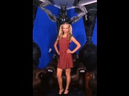 Kate is sited on a sofa, legs appart and looking at you