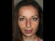 Adriyana is sited on a sofa, legs appart and looking at you