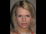 Yvetta is sited on a sofa, legs appart and looking at you