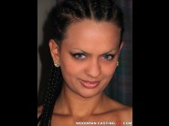 Anet mendelson is sited on a sofa, legs appart and looking at you