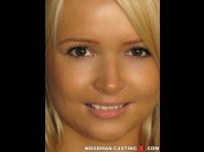 Alloa blondi is sited on a sofa, legs appart and looking at you