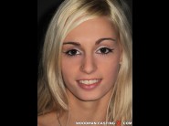 Erica fontes is sited on a sofa, legs appart and looking at you