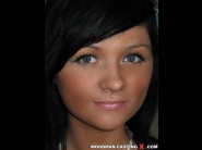 Bella margo is sited on a sofa, legs appart and looking at you