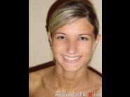 Oxiana is sited on a sofa, legs appart and looking at you