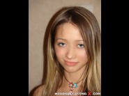 Ira is sited on a sofa, legs appart and looking at you