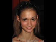 Peneloppe ferre is sited on a sofa, legs appart and looking at you