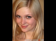 Freshblonde is sited on a sofa, legs appart and looking at you