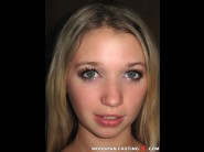 Mirka is sited on a sofa, legs appart and looking at you