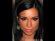 Ashley bulgari is sited on a sofa, legs appart and looking at you