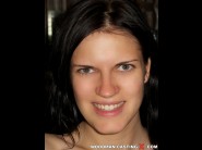 Mia is sited on a sofa, legs appart and looking at you