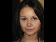 Liza shay is sited on a sofa, legs appart and looking at you