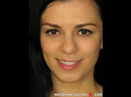 Elisabeth is sited on a sofa, legs appart and looking at you