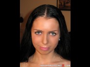 Isabella is sited on a sofa, legs appart and looking at you