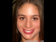 Cathy heaven is sited on a sofa, legs appart and looking at you