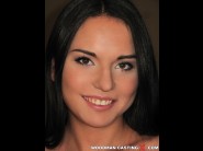 Nataly gold is sited on a sofa, legs appart and looking at you