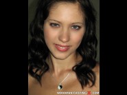 Aspen is sited on a sofa, legs appart and looking at you