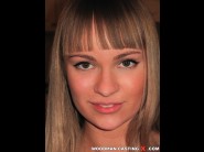 Melita is sited on a sofa, legs appart and looking at you