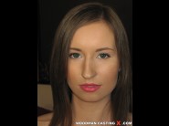 Kate shira is sited on a sofa, legs appart and looking at you