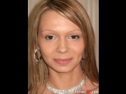 Marcella is sited on a sofa, legs appart and looking at you