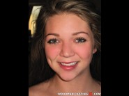 Jessie andrews is sited on a sofa, legs appart and looking at you