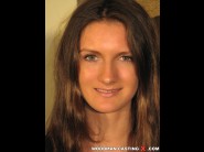 Jeycy fox is sited on a sofa, legs appart and looking at you