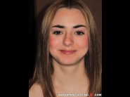  is sited on a sofa, legs appart and looking at you