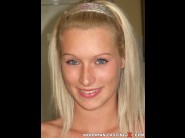 Kittie ku is sited on a sofa, legs appart and looking at you