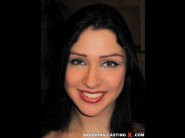 Rita ocelo is sited on a sofa, legs appart and looking at you