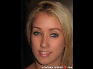 Kendra watson is sited on a sofa, legs appart and looking at you