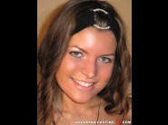 Alicija is sited on a sofa, legs appart and looking at you