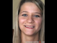 Lylla is sited on a sofa, legs appart and looking at you