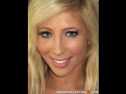 Tasha reign is sited on a sofa, legs appart and looking at you