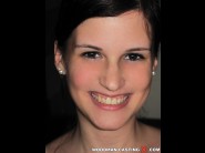 Celinange is sited on a sofa, legs appart and looking at you