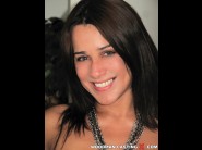 Shannya tweeks is sited on a sofa, legs appart and looking at you