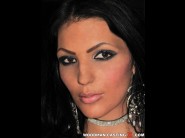 Sandra long is sited on a sofa, legs appart and looking at you