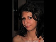 Bettina is sited on a sofa, legs appart and looking at you