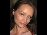 Sophie lynx is sited on a sofa, legs appart and looking at you