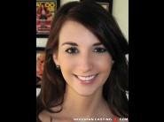 Katie jordin is sited on a sofa, legs appart and looking at you