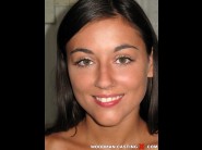 Iwia is sited on a sofa, legs appart and looking at you