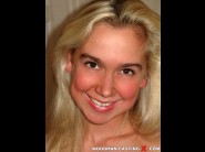 Poly is sited on a sofa, legs appart and looking at you