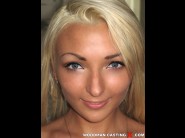 Alyn borav is sited on a sofa, legs appart and looking at you