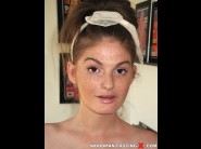 Faye reagan is sited on a sofa, legs appart and looking at you