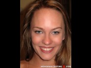 Blue angel is sited on a sofa, legs appart and looking at you