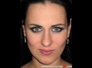 Mea melone is sited on a sofa, legs appart and looking at you