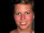 Gabriella is sited on a sofa, legs appart and looking at you