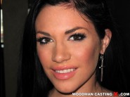 Andy san dimas is sited on a sofa, legs appart and looking at you