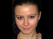 Kristy is sited on a sofa, legs appart and looking at you