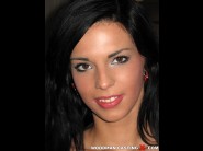 Alyssia loop is sited on a sofa, legs appart and looking at you