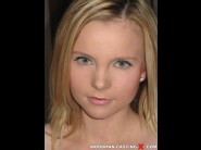 Lucyka is sited on a sofa, legs appart and looking at you